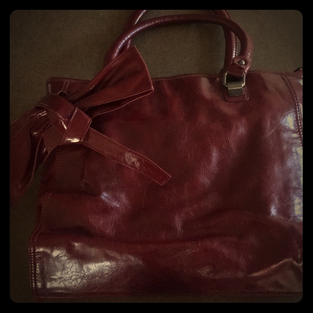 Deep red purse with bow and chrome detailing